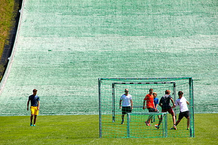 men playing soccer during daytime thumbnail