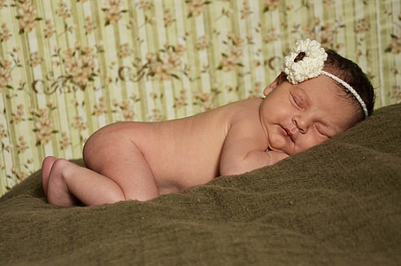 baby lying on brown textile thumbnail