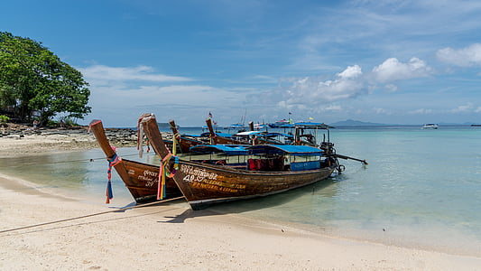 two brown-and-blue fishing boats thumbnail