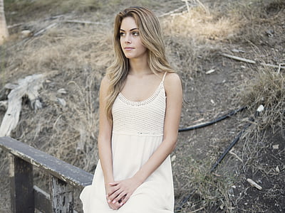 woman wearing white spaghetti strap dress sitting on fence thumbnail