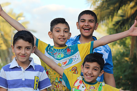 selective focus photography of four boys beside each other thumbnail