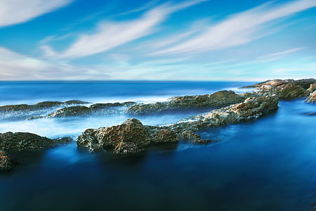 aerial photography of an island in the middle of sea during daytime thumbnail