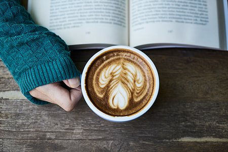 person holding white ceramic mug filled with coffee thumbnail