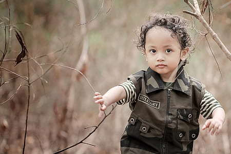 girl standing near brown grass thumbnail