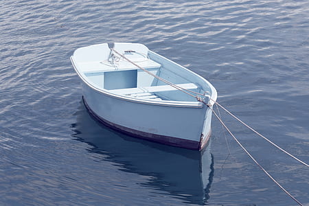 white wooden boat in body of water thumbnail