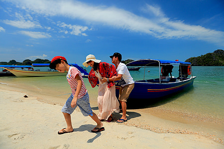 three people pulling blue boat out of the water under blue sky during daytime thumbnail