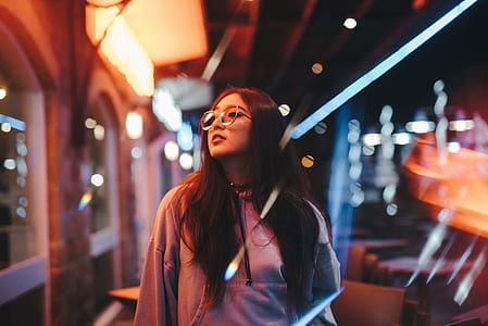 shallow focus of woman in gray long-sleeved top with eyeglasses thumbnail