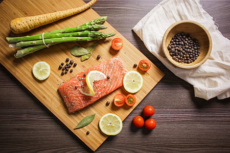 slice fish with asparagus on brown chopping board thumbnail