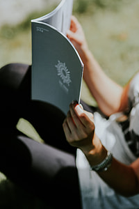 Woman reading a magazine outdoors thumbnail