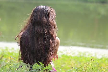 girl wearing pink top standing near green plants at daytime thumbnail