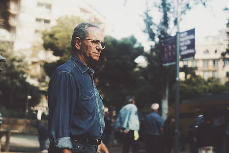 man standing in front metal post thumbnail