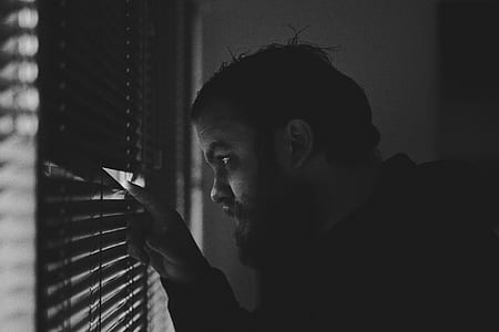 man peeking on window blinds thumbnail