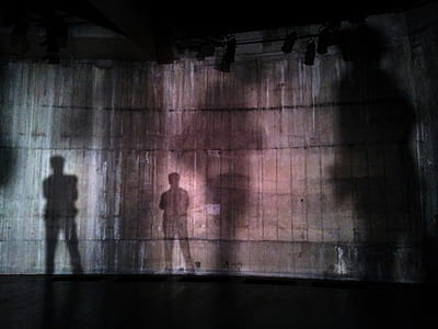 persons shadows on stage thumbnail