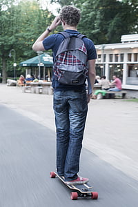 man doing skateboarding on road thumbnail