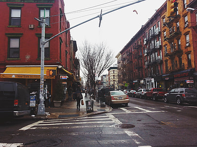 man standing on road near buildings thumbnail