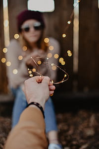 boke photography of woman sitting beside wall thumbnail