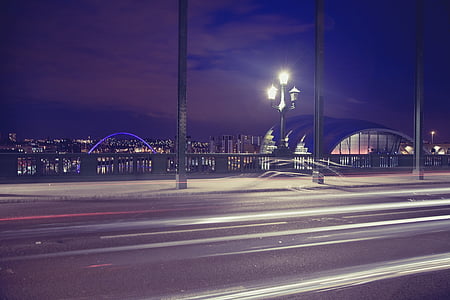 concrete road with lamp posts during nighttime thumbnail