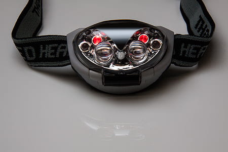 oval black and gray headlamp on white surface thumbnail