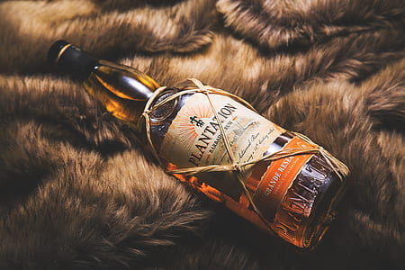 Plantation liquor glass bottle on brown fur textile thumbnail