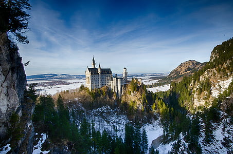 white concrete castle near mountain thumbnail