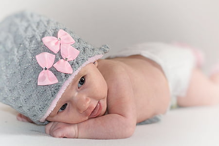 baby in gray and pink knit cap thumbnail