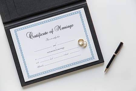 band rings on certificate of marriage thumbnail