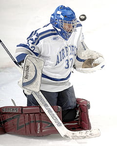 person wearing hockey uniforms kneeling on hockey field thumbnail