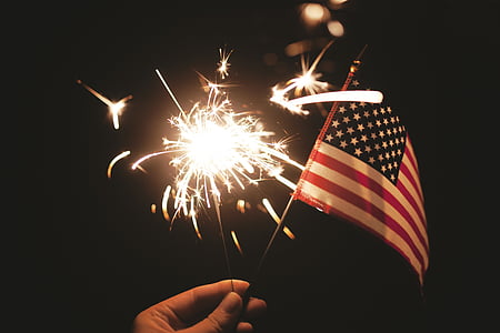 person holding USA flag and fire cracker thumbnail