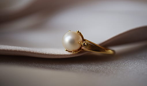 gold-colored ring with white pearl thumbnail