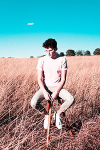 man in white shirt sitting on red chair thumbnail