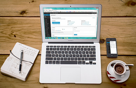 MacBook Air on brown wooden table thumbnail