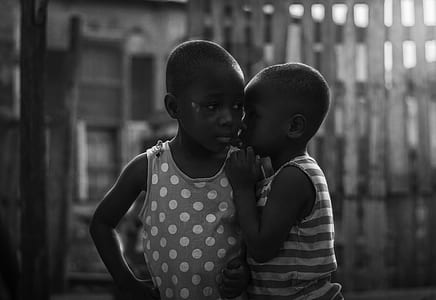 girl whispering to another girl silhouette photo thumbnail