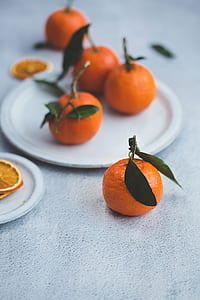 orange fruits on round white ceramic plate thumbnail
