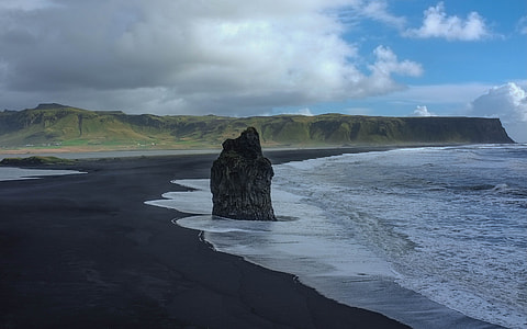rock monolith in the middle of the seashore thumbnail