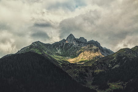 aerial photography of mountain under cloudy sky at daytime thumbnail