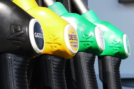 four assorted-colored fuel pump nozzles thumbnail