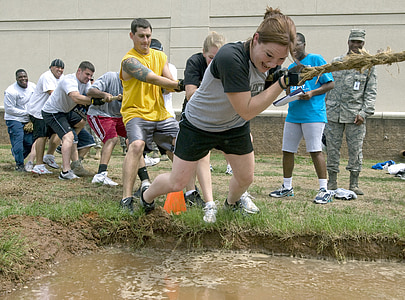 woman wearing gray and black crew-neck shirt while playing tug of war thumbnail