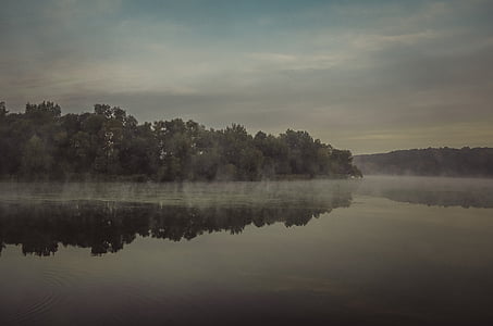 body of water under gray sky thumbnail