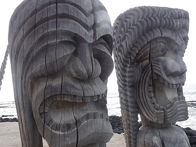 two grey wooden totem decor during daytime thumbnail