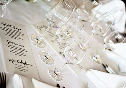 three clear wine glasses on white surface thumbnail