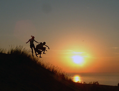 Jumping down the hill at sunset thumbnail