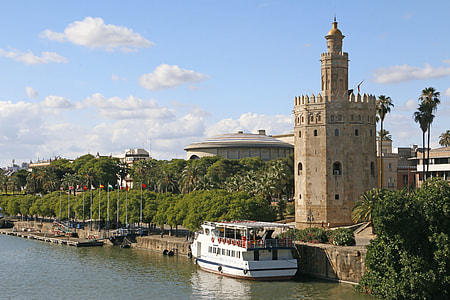 white and red ship beside brown concrete tower during daytime thumbnail