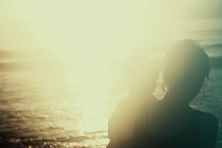 silhouette of woman and baby near sea thumbnail