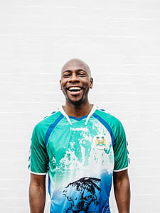man in teal, blue, and white shirt thumbnail