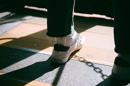 person wearing white and-black lace-up sneakers thumbnail