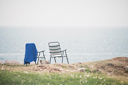 two white chairs overlooking sea thumbnail