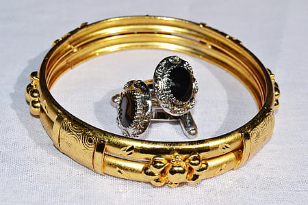 gold-colored bracelet on white surface thumbnail