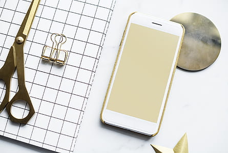 white Android smartphone near shears thumbnail