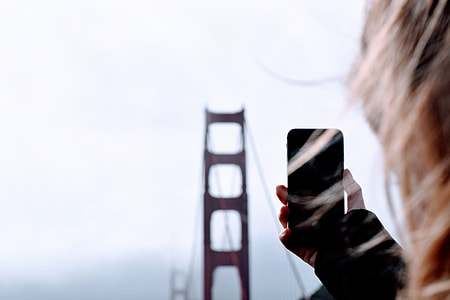 person holding smartphone and facing to Golden Gate Bridge thumbnail