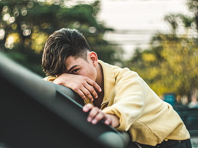 selective focus photography of man wearing yellow dress shirt thumbnail
